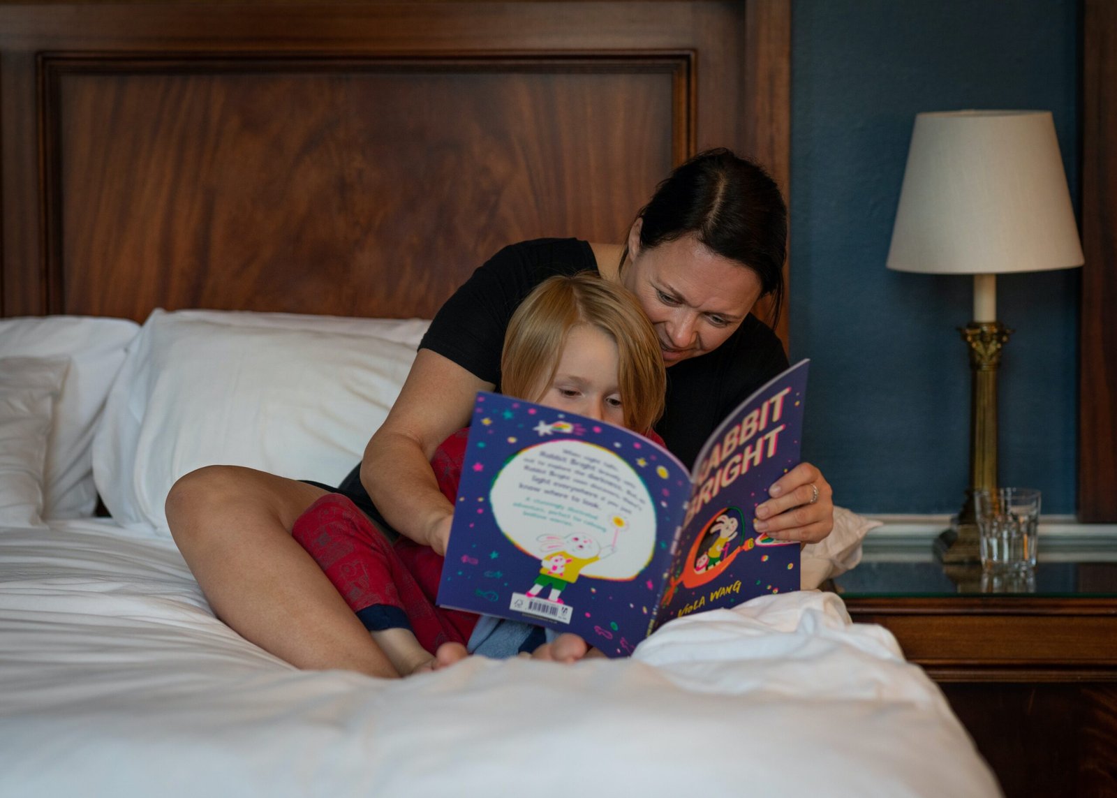 A mother sharing A bedtime Stories on Christian faith with daughter