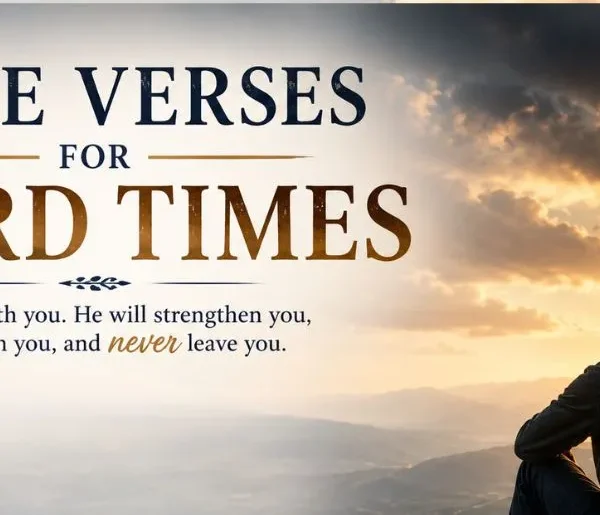 Bible verses for hard times feature image showing a person sitting on a rocky mountain overlook at sunrise, gazing toward a glowing cross in the distance.